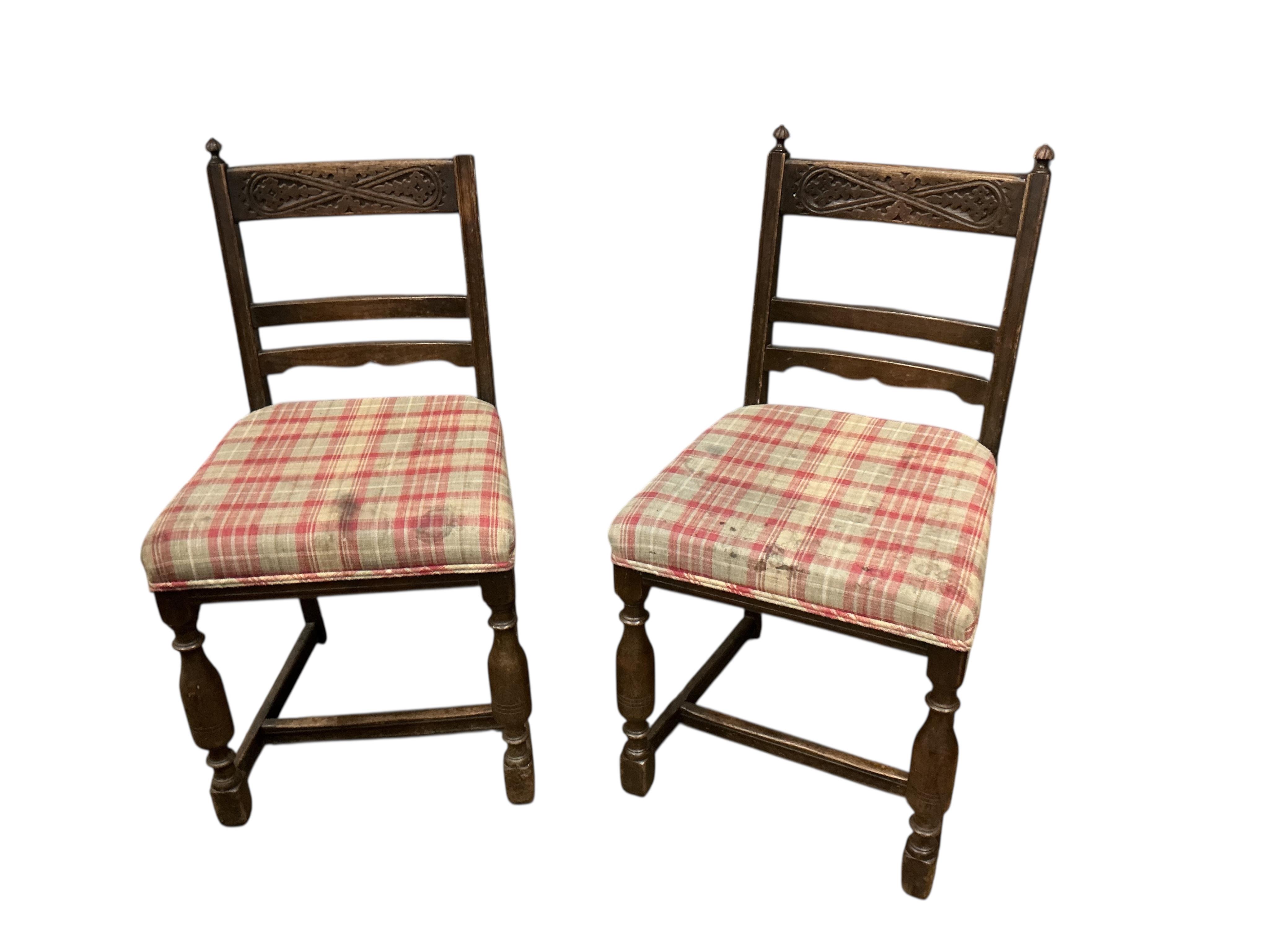 An 18th century style rectangular oak extending draw leaf refectory table, width 136cm, depth 80cm, height 78cm together with four carved oak dining chairs